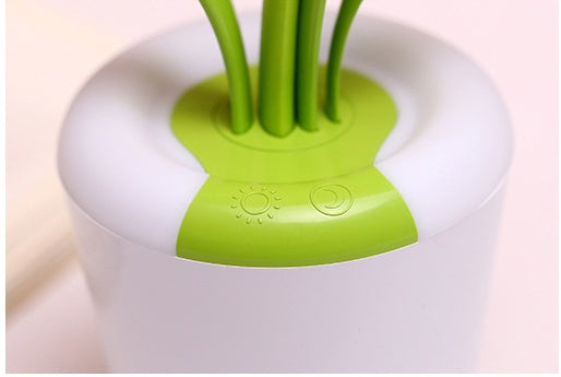 Green and white grooming tool on a light pink background