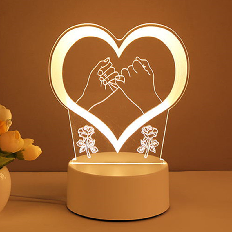 Heart-shaped night light with hands holding a flower and roses on a brown background